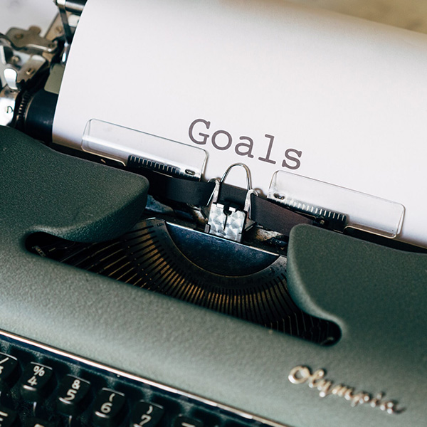 Resolutions Suck, a type writer with the letter writing your "Goals." A title card for New Year's